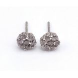 A Pair of 18K White Gold and Diamond Stud Earrings. 14 diamonds in total - 0.40ct. 1.20g total