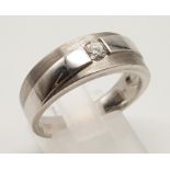 An 18K White Gold Diamond Set Band Ring. 0.20ct. Size S. 7.6g.