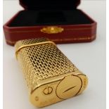 A Gold Plated Cartier Lighter. Excellent condition. In original box with booklet. 6 x 3cm.