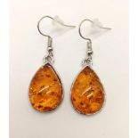 A Pair of Amber Cabochon Earrings on White Metal.