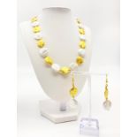 A rarely seen, coin shaped, large pearls and 18 K yellow gold plated spacer beads in a necklace