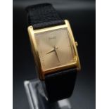 A Piaget 18K Gold and Diamond Ladies Quartz Watch. Black leather strap with 18k gold buckle. 18k