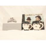 A LAUREL AND HARDY COLLECTION COMPRISING OF 21 DVD IN BOXSET FORM, A BOOK AND A LAUREL MUG AND HARDY