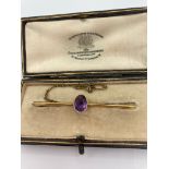 Antique Edwardian 15 carat GOLD bar brooch having AMETHYST stone set to centre. Presented in