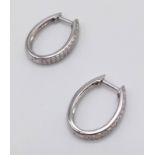 A Pair of 14K White Gold and Diamond Hoop Earrings. 0.70ct. H-VS Grade. 3.14g total weight.