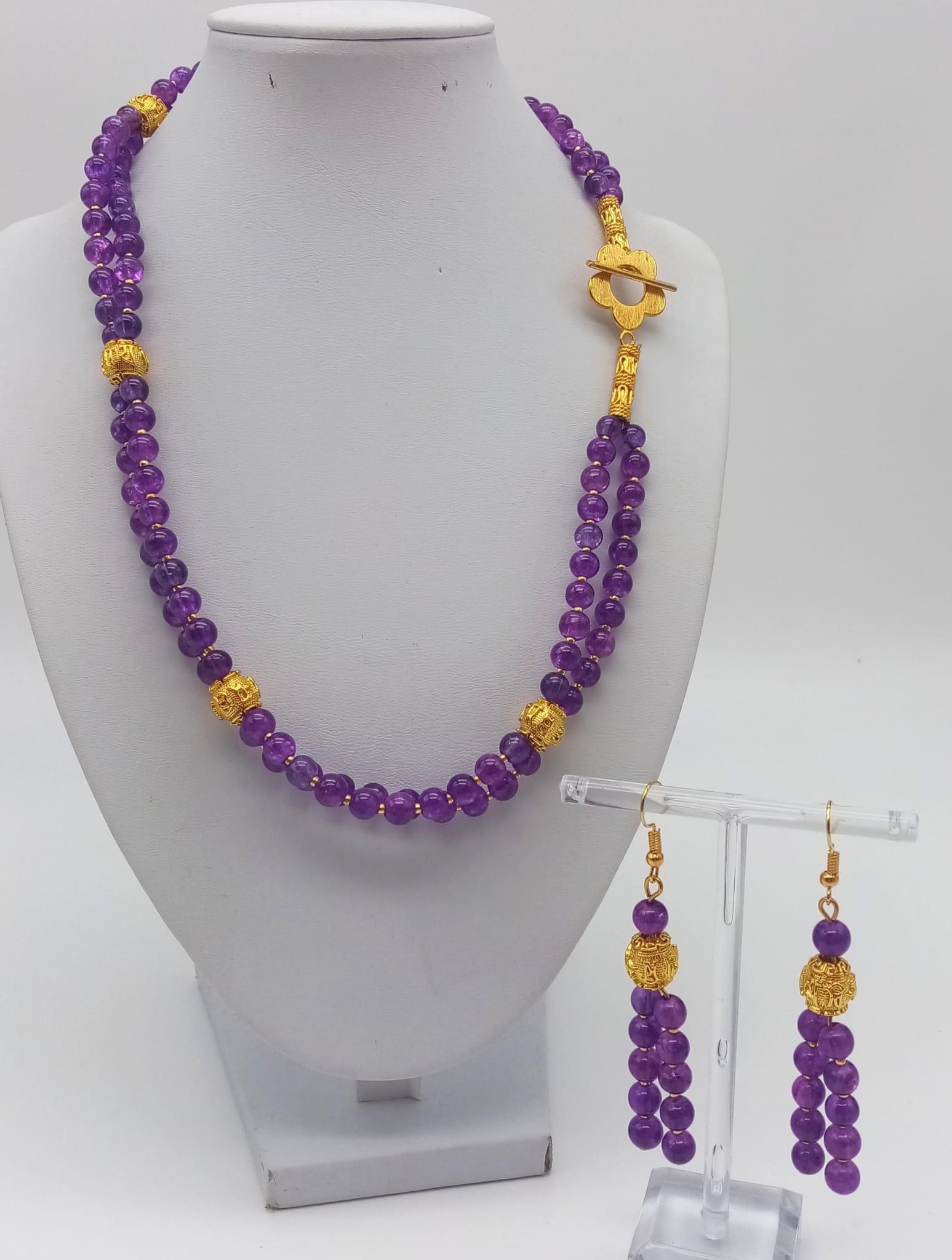 A double row of round amethysts necklace and earrings set with 18 K yellow gold plated highlights.