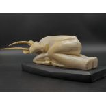An Antique Chinese Meije Period Ivory Sleeping Antelope on a Wooden Base. 1.550k total weight.
