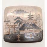 An antique Japanese solid silver cigarette case with images of Mount Fuji, pagodas, etc, on exterior