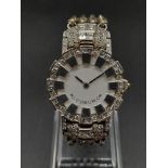 An 18K White Gold and Diamond Corum Ladies Watch. 18K white gold strap and case - 25mm. Diamond