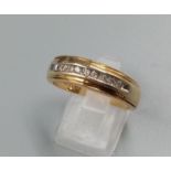 A 9 K yellow gold ring with band of diamonds. Ring size: T, weight: 5.3 g.