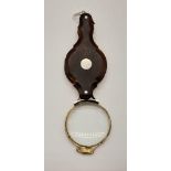 A Victorian magnifying glass with tortoise shell covers. length: 6.8 cm.