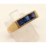 A 9K Yellow Gold Three-Stone Sapphire Ring. Size V. 4.2g