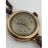 An Antique 9K Gold Ladies Watch. Original leather strap. Gold case - 23mm. Not working so A/F. 16.3g
