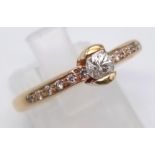 A 14K Yellow Gold Diamond Ring. Centre stone with diamonds on shoulders - 0.30ct. Size N. 4.2g