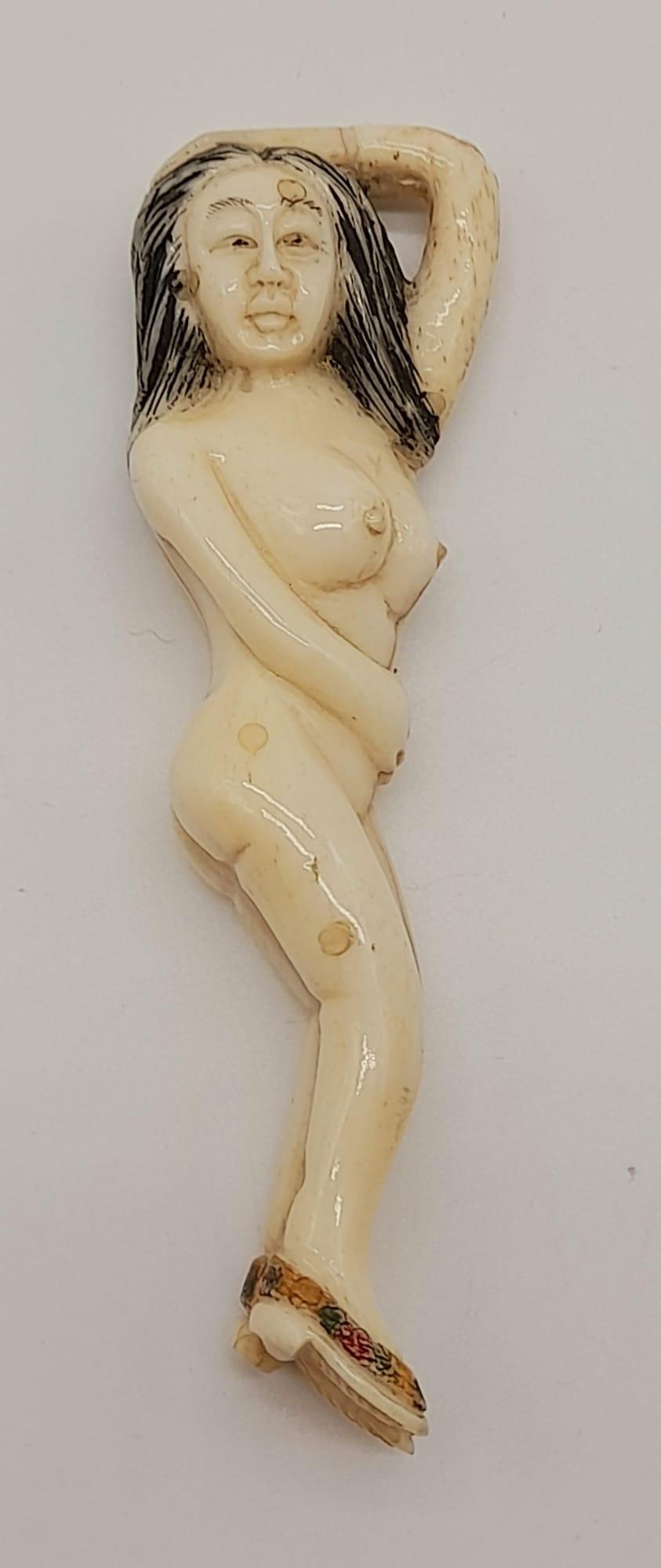 A 19th Century Japanese, carved ivory figure of a naked lady, wearing her shoes. Height: 9.7 cm,