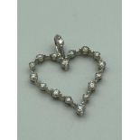 18 carat WHITE GOLD and DIAMOND heart pendant having full UK hallmark with 17 small high grade