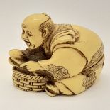 An antique Japanese carved ivory netsuke, in the form of an oyster catcher searching for pearls.