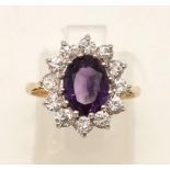 A 9K Yellow Gold Amethyst and White Stone Ring. Size K. 2.06g