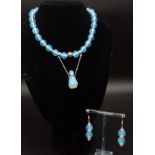 A moonstone necklace with an unusual perfume bottle pendant and matching earrings in a