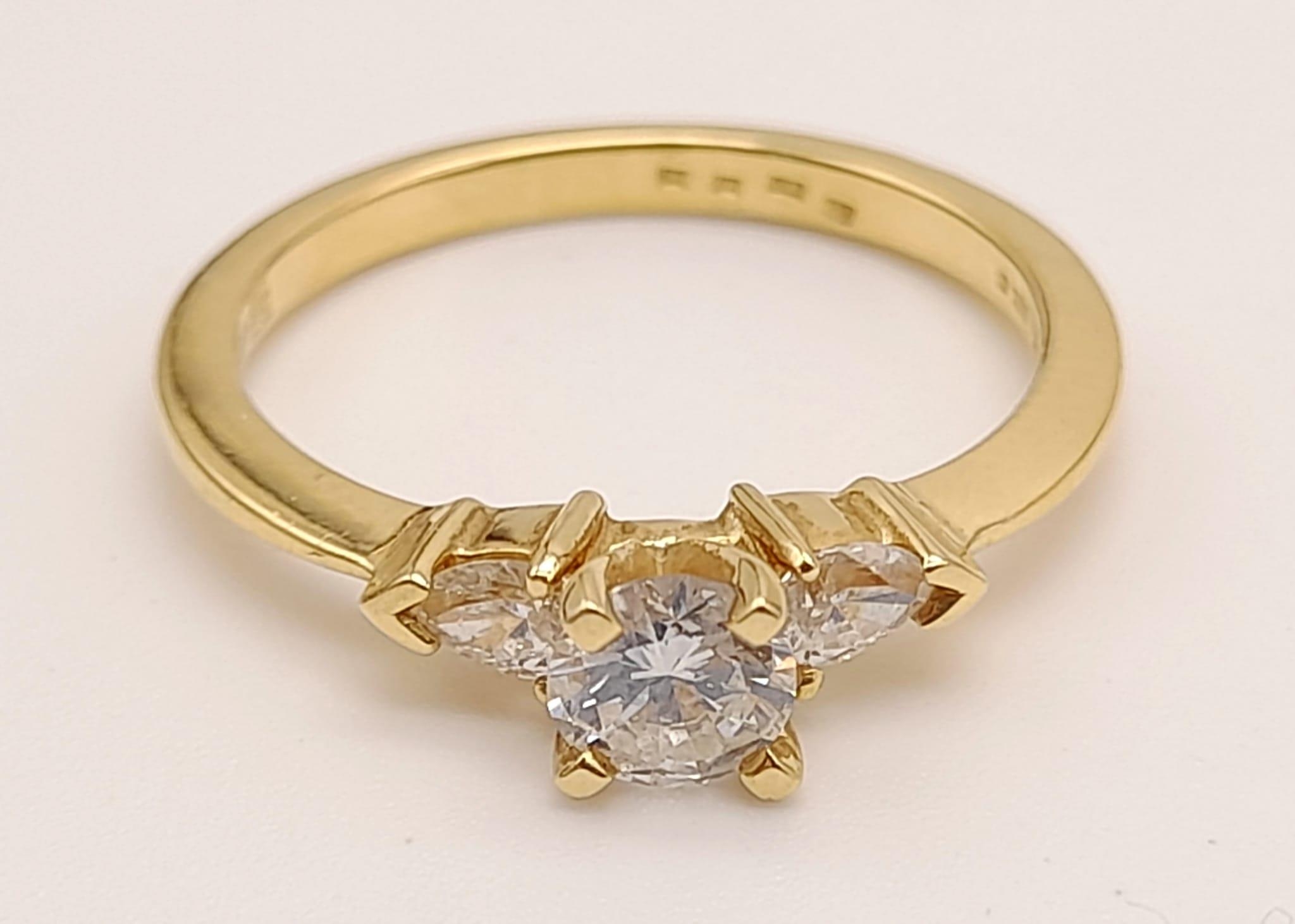An 18K Yellow Gold Three-Stone Diamond Ring. 0.60ct. Size N. 3g.