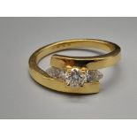 An 18K Yellow Gold Three-Stone Diamond Twist Ring. 0.63ct. Size N. 4.6g.