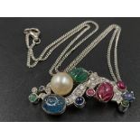 A 14K White Gold Ruby, Diamond, Emerald, Pearl and Diamond Pendant - On a disappearing silver