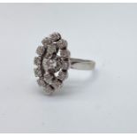 A VERY PRETTY 18K WHITE GOLD DIAMOND CLUSTER RING IN AN ATTRACTIVE OVAL SHAPE. 4.7gms size L