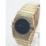 AN OMEGA CONSTELLATION 18K GOLD LADIES WATCH WITH NDIAMOND ENCRUSTED BEZEL, SOLID GOLD STRAP AND