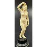A 19th Century French carved ivory figurine of a naked lady on a pedestal. Height: 11 cm, total