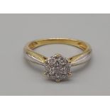 An 18K Yellow Gold Diamond Cluster Ring. Size K. 0.25ct. 2.5g