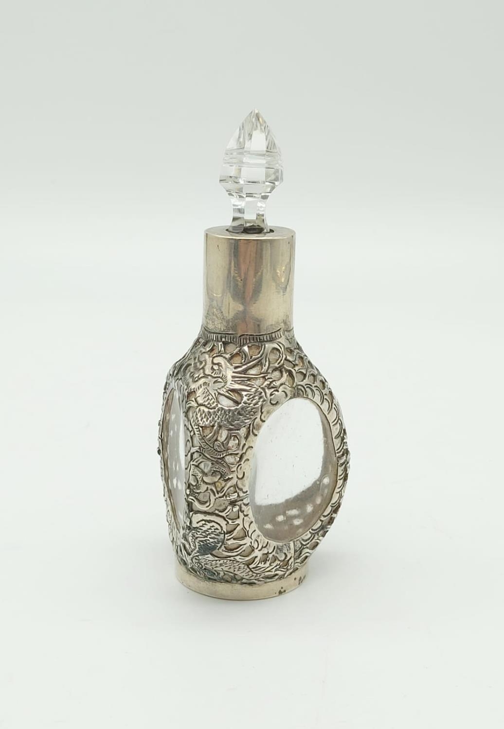 An Antique Chinese Sterling Silver Bottle with Crystal Glass Topper. Pierced Dragon and Flower