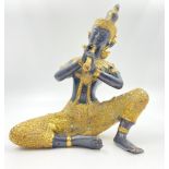 A Vintage Bronze Thai Buddha Deity Playing a Flute. Gilded decoration throughout. 20cm tall.