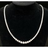 An 18K White Gold Graduated Diamond Necklace. An immense 10ct of magnificent sparkling graduated