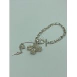 SILVER BRACELET with filigree cross pendant having ?T - bar? fastening and padlock showing 925