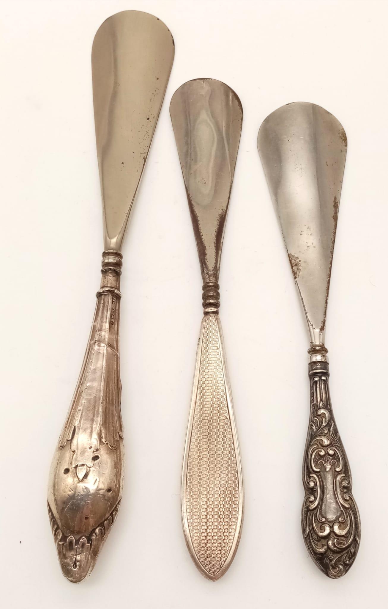 Three Antique Silver Handled Shoehorns. Hallmarks for Birmingham 1908, 14 and 25. 23cm - longest
