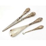A Three Piece Victorian Outerwear Set. Glove removers - 17cm. A shoe horn - 16cm and a boot button