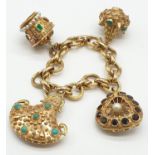 A vintage 21ct yellow gold large and chunky Eastern style charm bracelet set with seed pearls,