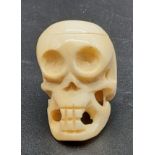 An early Japanese, carved ivory pendant in the form of a human skull. Dimensions: 4 x 3 x 2.5 cm,