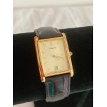 Gentlemans PULSAR quartz wristwatch in gold tone having square face with date window and quality