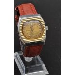 A 1960s Radu Gents Silver Sabre Watch. Brown leather strap. Stainless steel and gold-plated case -