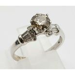 An 18K White Gold and Champagne Diamond Solitaire Ring. 0.65ct. I2 - Grade. Size J. 2.8g.