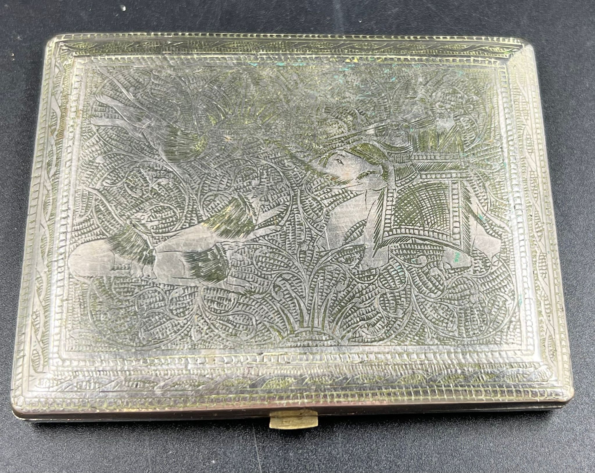 An Antique Indian Solid Silver Cigarette Case. Engraved with images of elephants and lions. Hinge