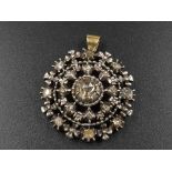 A Vintage Diamond and Yellow Gold Pendant. Central diamond surrounded by two rows of outer