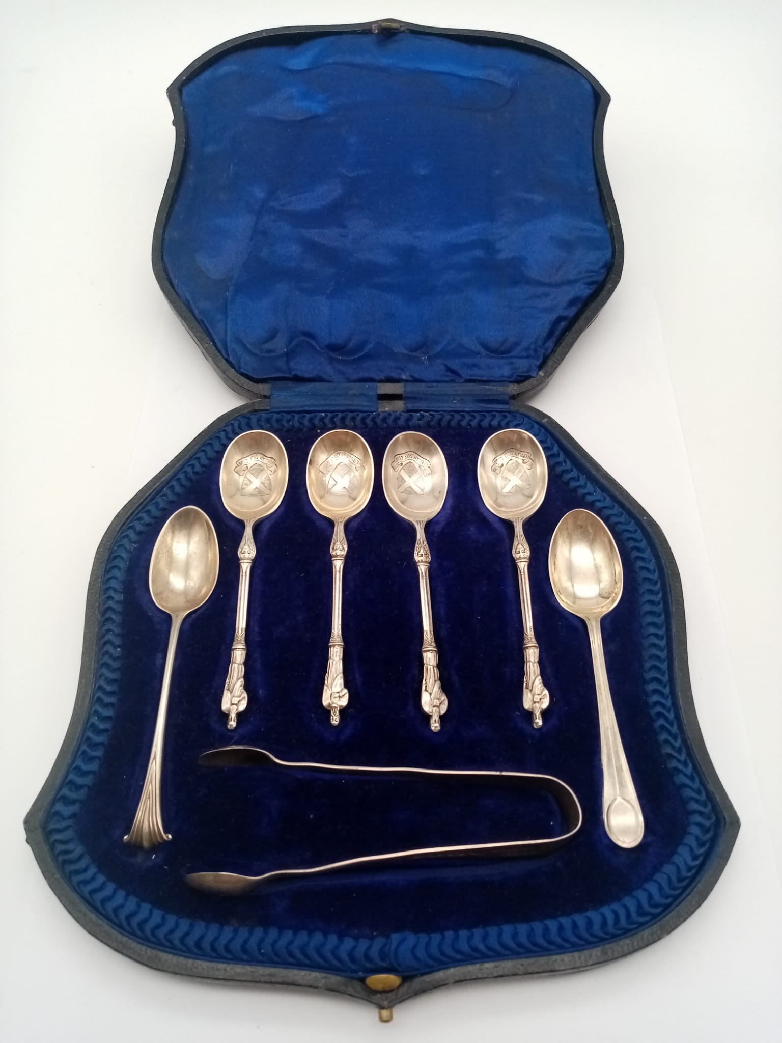 An Antique Mixed Solid Silver Teaspoons Lot. Four with a religious symbol handle. Sugar nips also