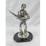 A SILVER STATUE OF THE FAMOUS JIMI HENDRIX STANDING 32cms TALL ON A BLACK WOODEN BASE. 1.6kg.