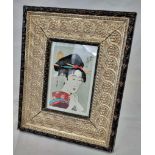 An antique Japanese woodblock print of a Geisha with an elaborate hairstyle. Hand made and hand
