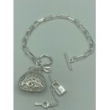 SILVER square link chain BRACELET having ?T? bar fastening with filigree purse pendant and padlock