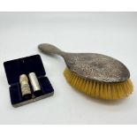 AN EARLY SILVER HAND CHASED BRUSH TOGETHER WITH A 1930'S SHAVING SET WITH BRUSH AND STYPTIC PENCIL