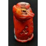 An antique, Chinese, red coral, snuff bottle, with carved bird on side. Top missing. Dimensions: 6.5