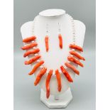 A statement necklace and earrings set with genuine red corals and cultured white pearls. Coral max